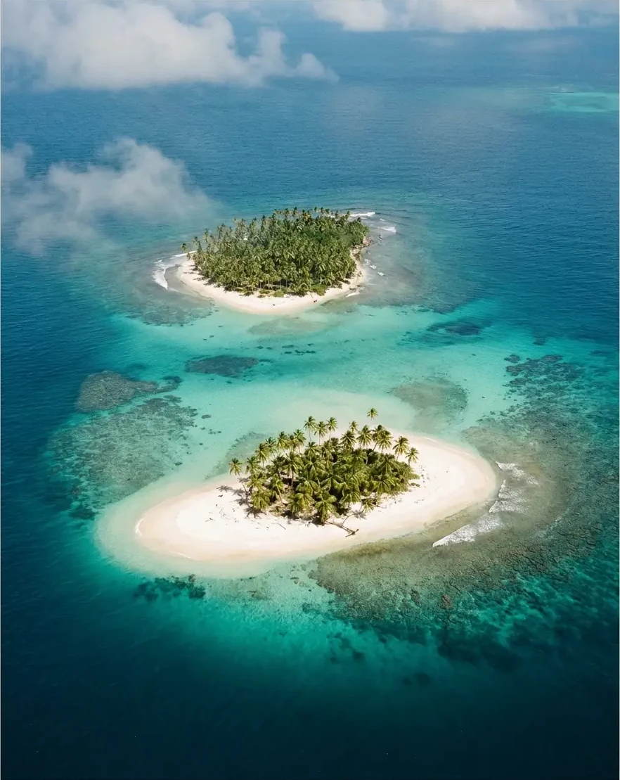 Aerial view of the two Zapatilla Cays ringed by white sand